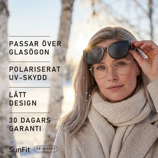 Kvinna med glasögon lyfter SunFit fit-over-solglasögon i vintersol över snö